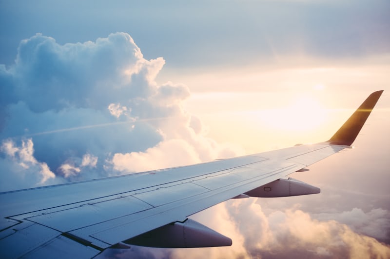 Aircraft wing above the clouds shortly after take-off from a London airport